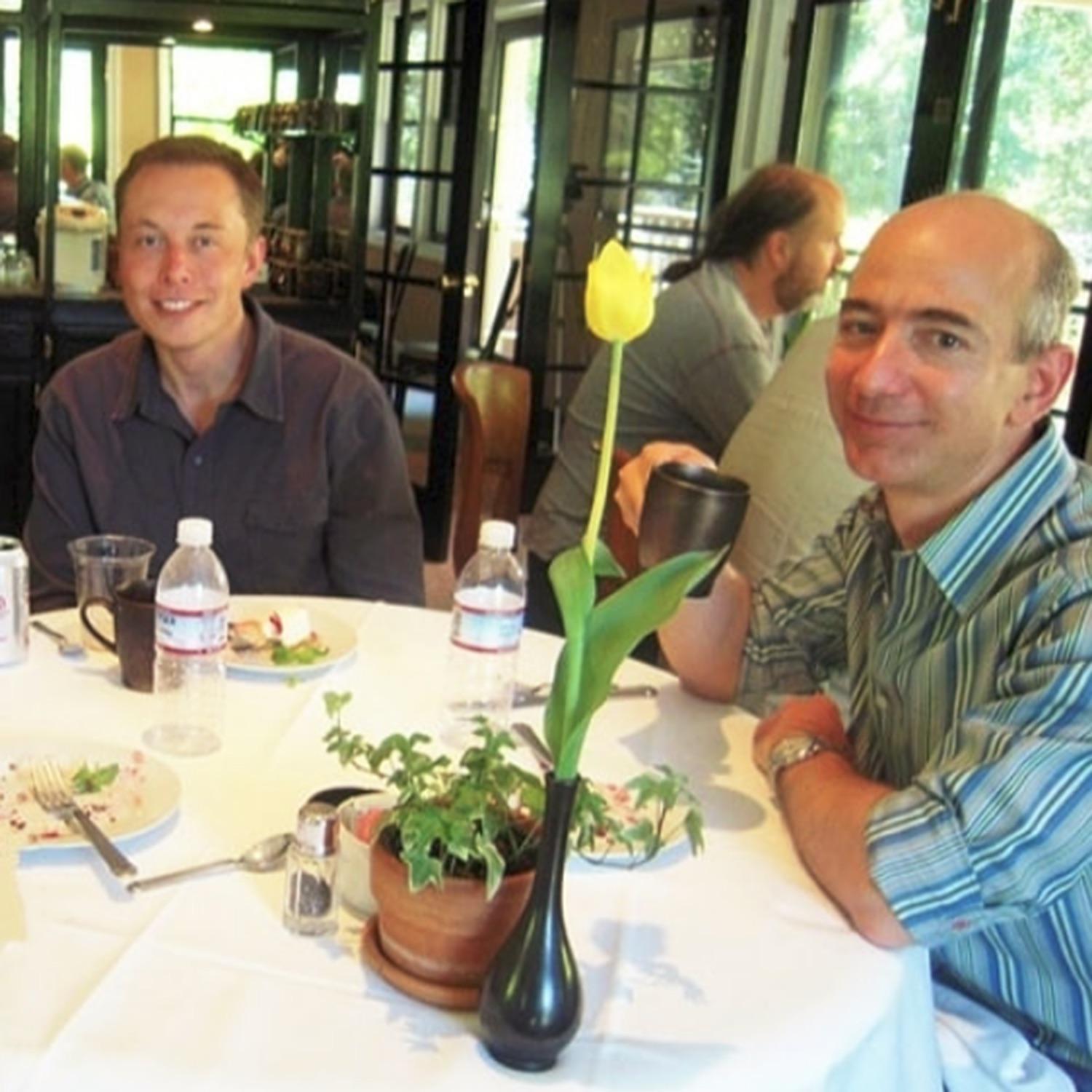Elon Musk and Jeff Bezos sit together for a meal in this early photograph.