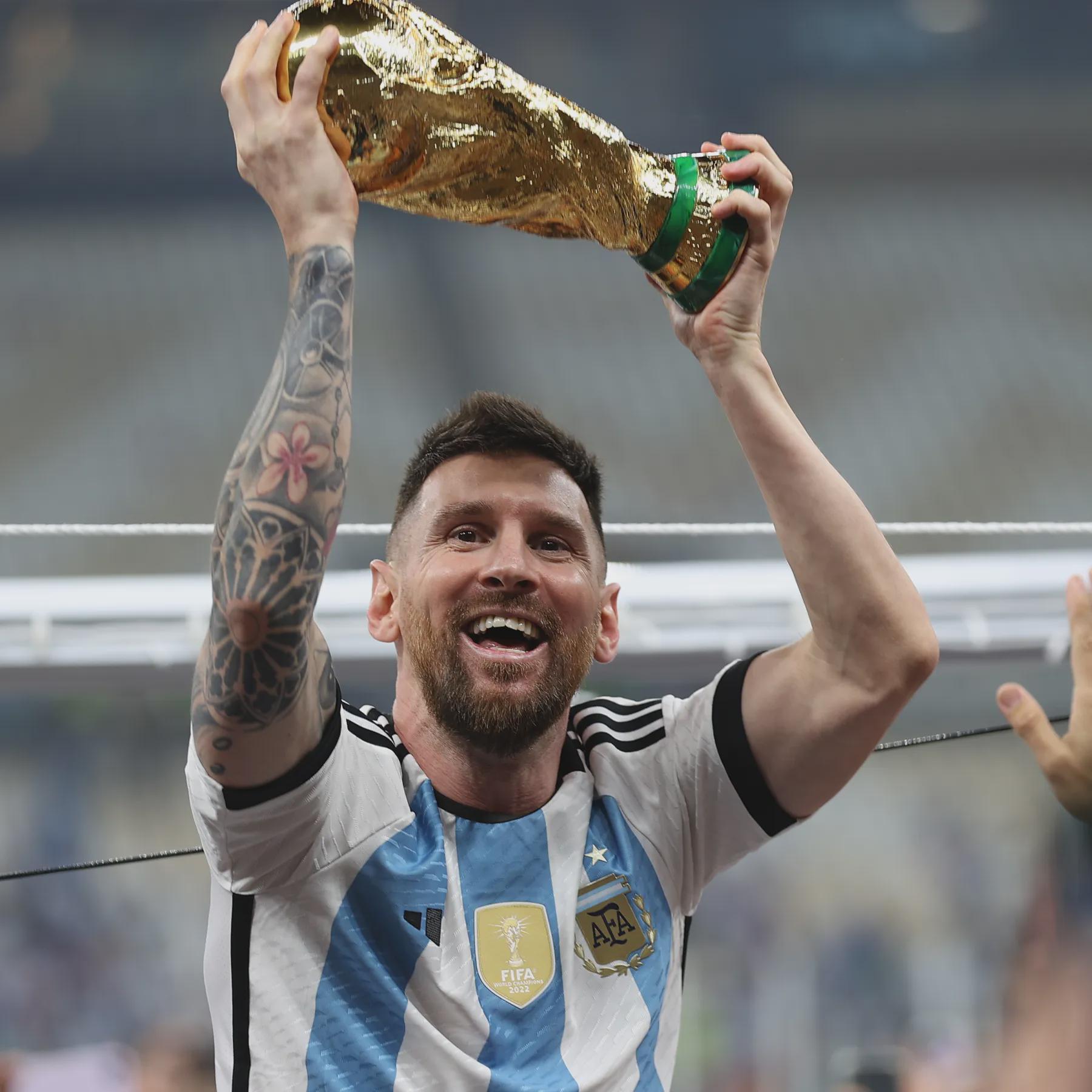 Lionel Messi celebrates with the World Cup trophy following Argentina's victory.