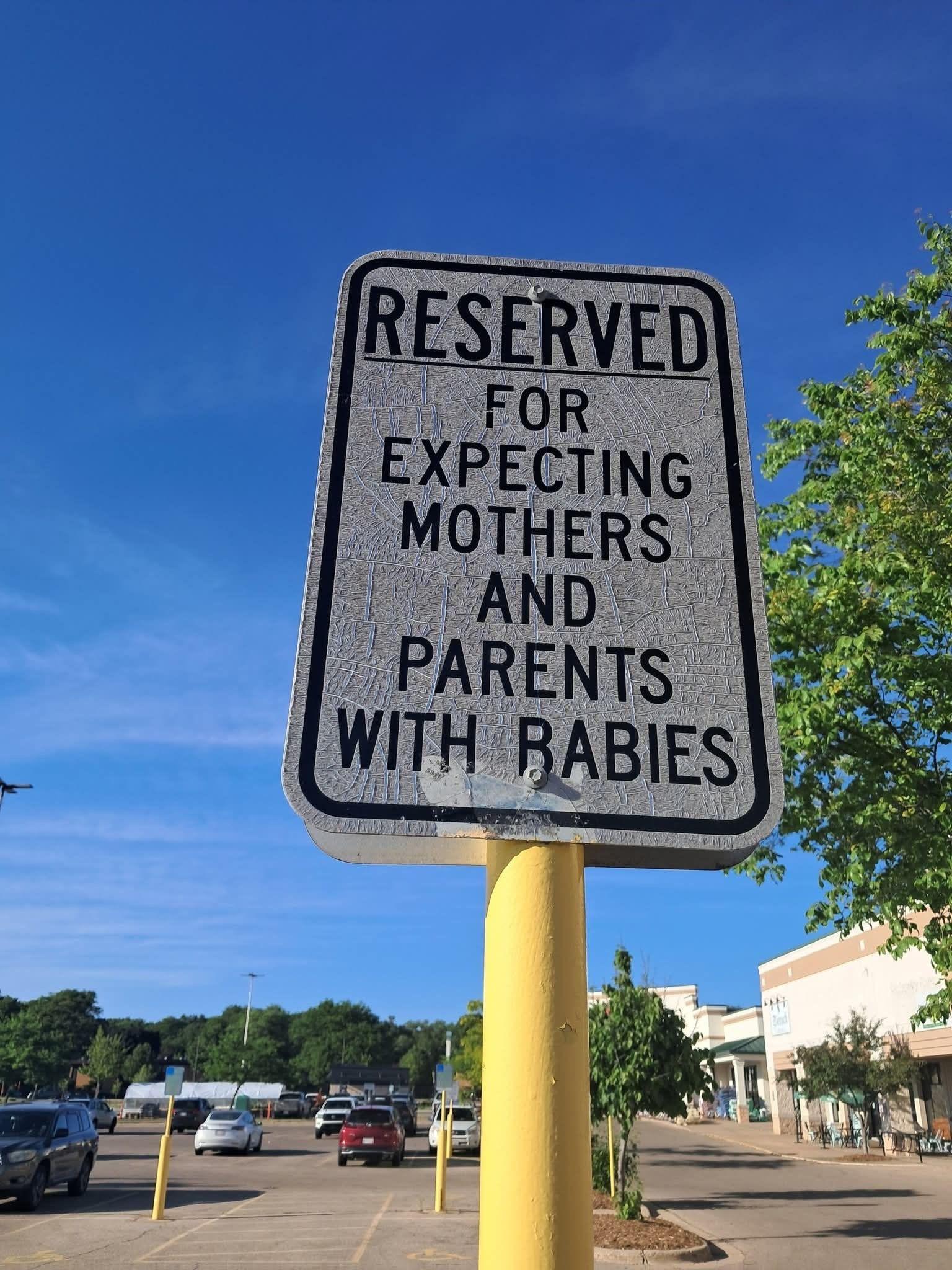 A reserved parking sign at a local shopping center highlights new accommodations for parents affected by the epidemic.
